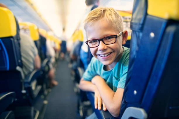 istock Smiling little boy travelling by plane 1151124507
