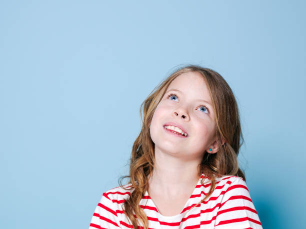 istock Thoughtful Girl Against Blue Background 1151127979