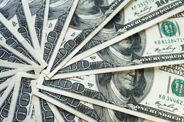 istock scrolled stack of 100 dollar bills, close up banknote 1151129500