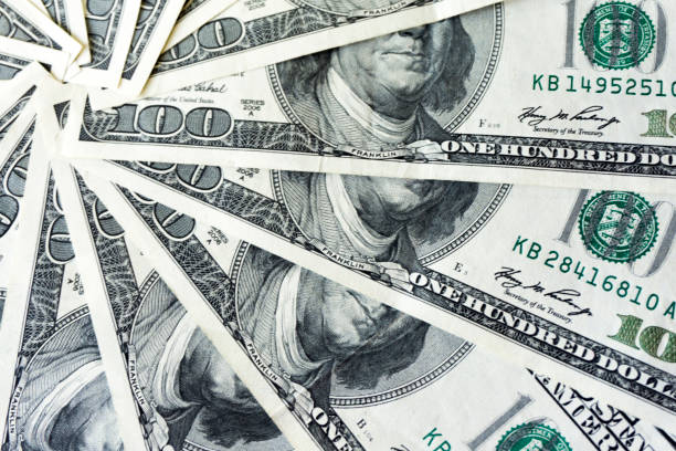 istock scrolled stack of 100 dollar bills, close up banknote 1151130020