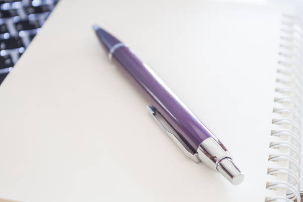 istock Close-Up Of Pen And Book 1151133141
