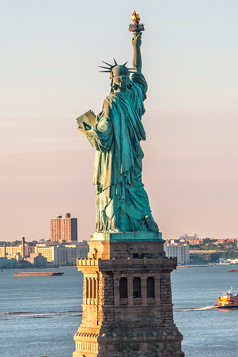 Back view from a helicopter on the Statue of Liberty in Upper bay, New York City.