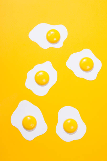 istock paper fried egg, set against a backdrop of yellow paper. Horizontal view over 1151135516