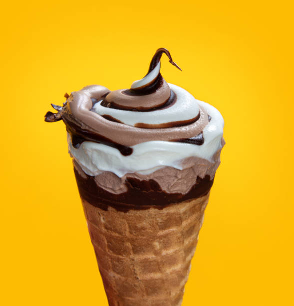istock chocolate cream ice cream in waffle cone on yellow background. 1151135576