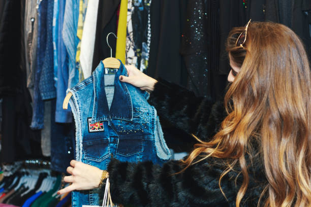 istock Young woman choosing clothes in the store 1151135896
