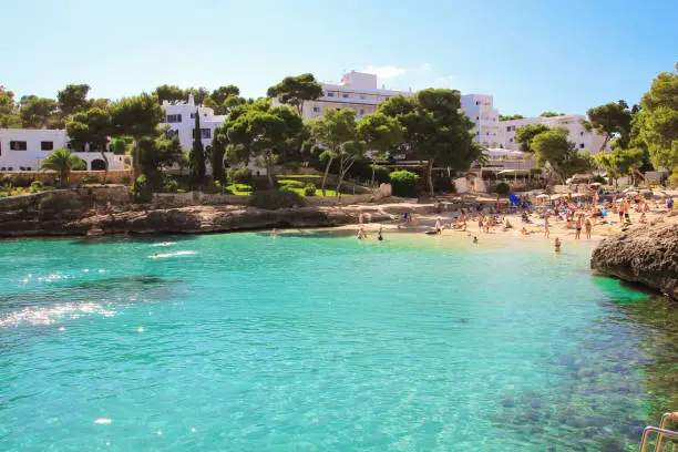 Photo of Beautiful Cala d'Or Beach in sunny summer day with turquoise water.