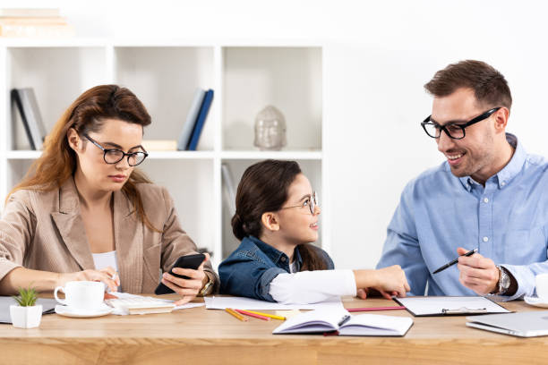 istock child in glasses looking at cheerful father working in office 1151137070