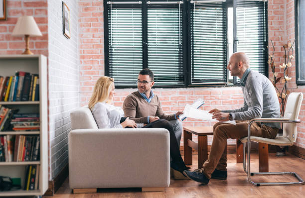 istock Young family consulting with a architect 1151138153