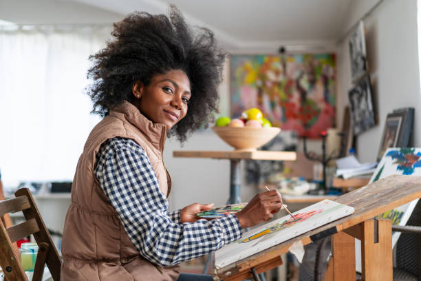 istock Young afro woman drawing 1151138178