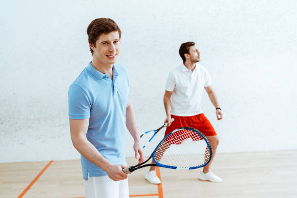 istock Handsome squash player in blue polo shirt looking at camera 1151139463