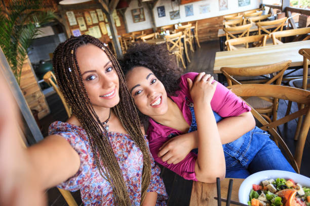 istock Two women having fun and taking selfie in restaurant 1151140144
