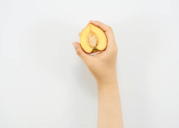 Female hand holding Ripe nectarine on a white background