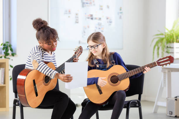 istock Music trainer showing sheet to female student 1151141428