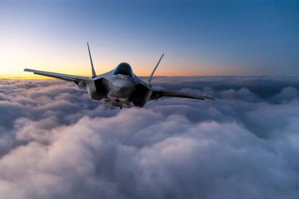istock Fighter Jet flying over the clouds at sunset 1151141434