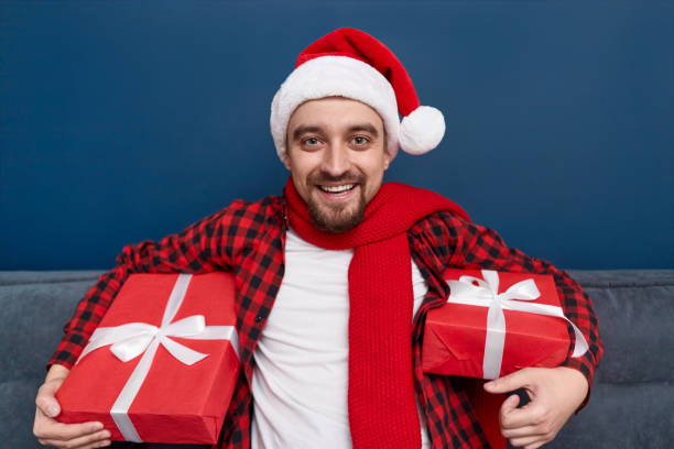 istock Cheerful guy with Christmas presents 1151141532