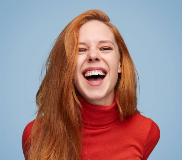 Vibrant laughing girl on blue background