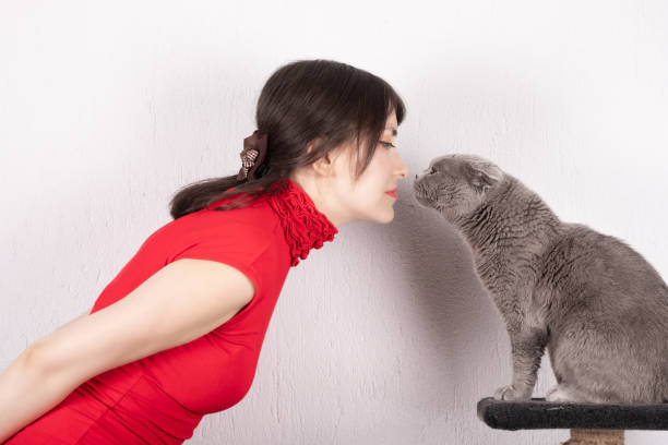 Cat Owner and Her Cat Looking Into Each Other's Eyes