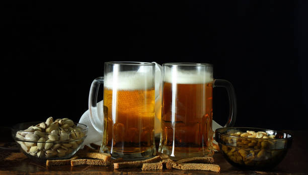 istock Two mugs of beer in a retro style 1151142417
