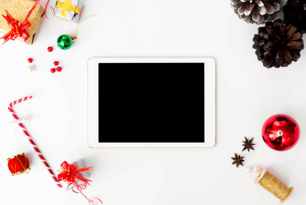 istock stylish tablet mockup for christmas time, christmas decorations on isolated white screen, flat lay top view. 1151143226