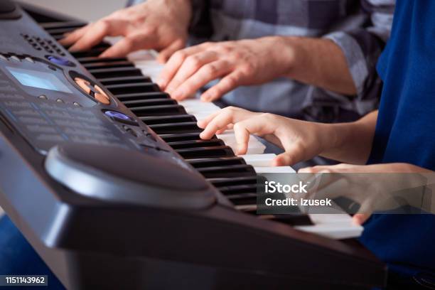 Trainer Teaching Piano To Boy In Class Stock Photo - Download Image Now - 12-13 Years, 30-34 Years, Adult