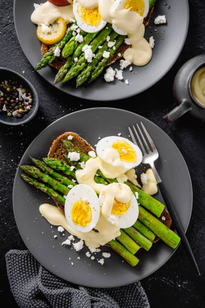 istock Tasty toasts with asparagus, eggs and sauce 1151144442