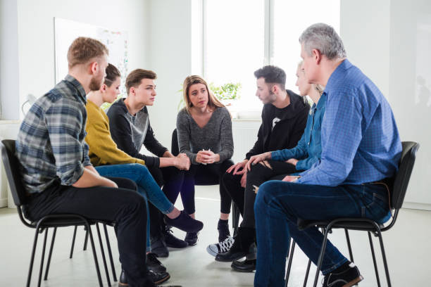 istock Male therapist assisting depressed young students 1151145226