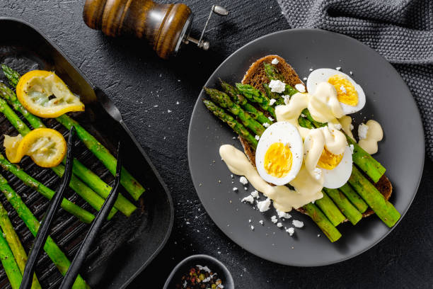 istock Tasty toasts with asparagus, eggs and sauce 1151145228