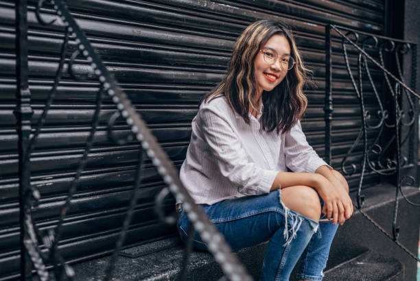 istock Cute young woman sitting on steps 1151146213