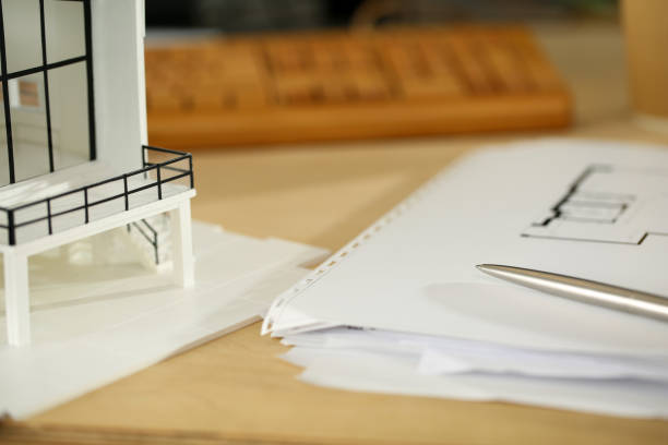 istock Silver pen lying at working table of architect with blueprints 1151147348