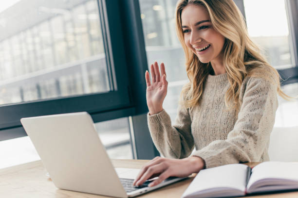 istock beautiful woman waving hand while having video call 1151147416