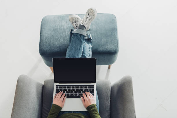 istock cropped view woman using laptop with blank screen at home 1151148983