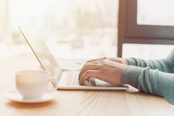 istock cropped view of man using laptop while working at home 1151149021