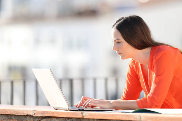 istock Self employed writing on laptop in a balcony 1151149401