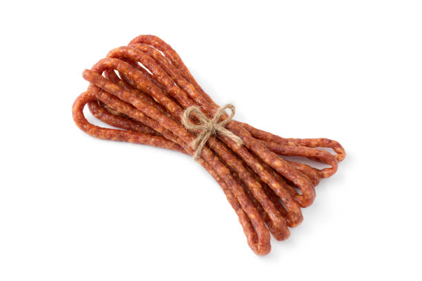 Polish thin Kabanosy sausage from pork meat close up isolated on white background