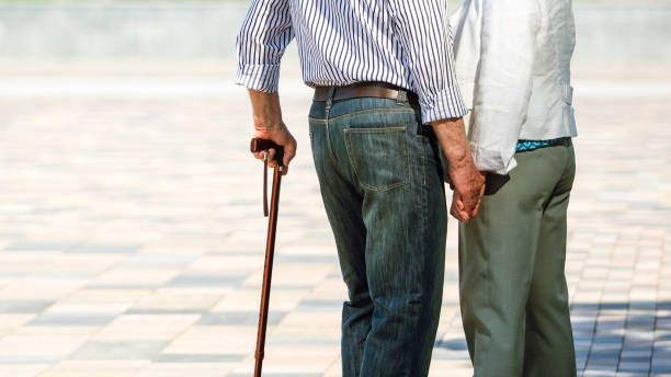 istock Senior adults walking in a park holding hands 1151151707
