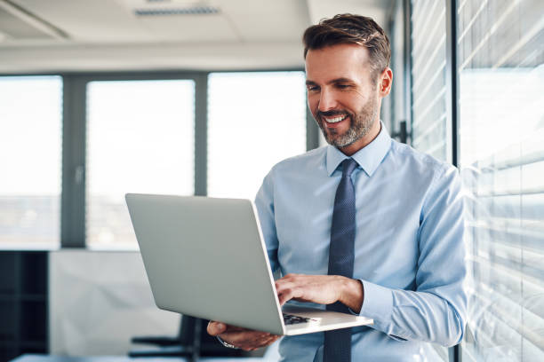 istock Businessman in modern office working on laptop 1151151766