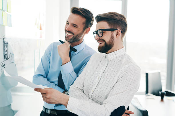 istock Two happy businessmen working in modern office 1151151884