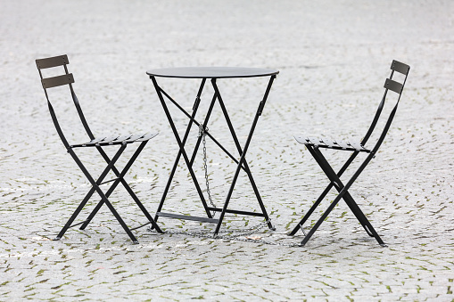 Table and chairs standing on a lawn at the garden