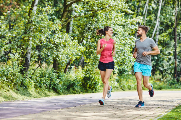 istock Happy couple running in park 1151152589