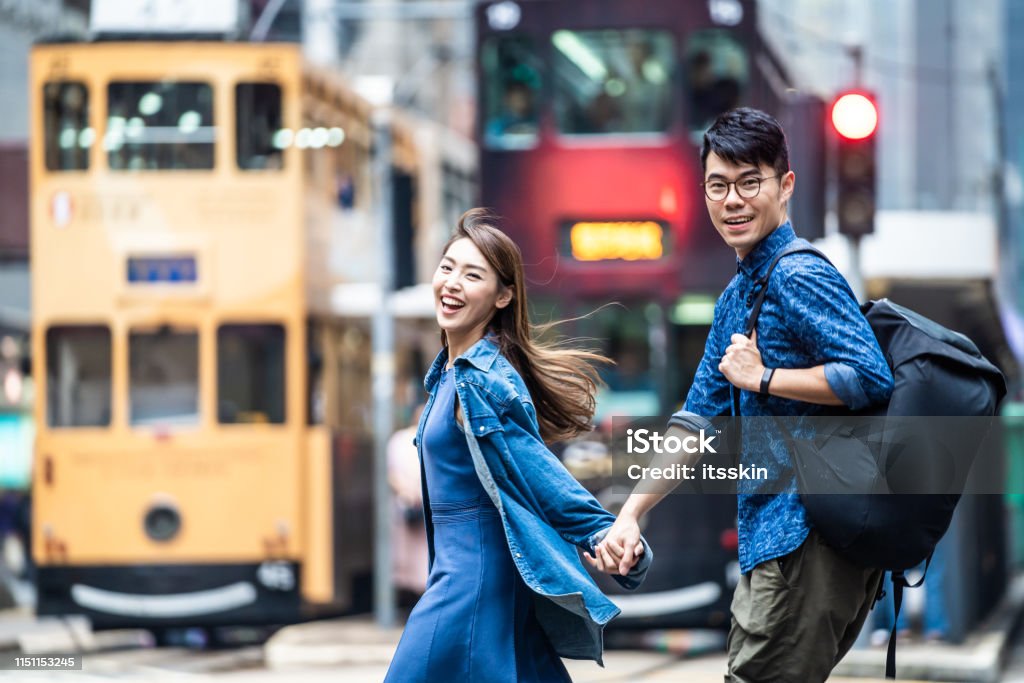 Two people walking in Hong Kong and holding hands. Hong Kong Stock Photo