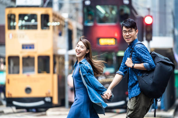 Two people walking in Hong Kong and holding hands. stock photo