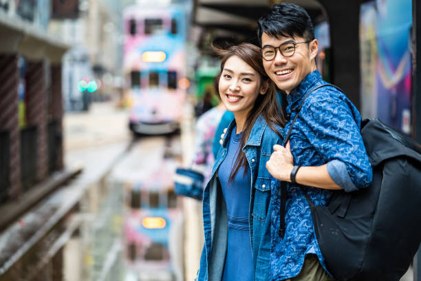 Two people are waiting for the tram in Hong Kong. stock photo