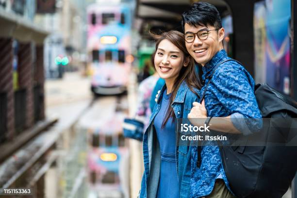 Two People Are Waiting For The Tram In Hong Kong Stock Photo - Download Image Now - Chinese Culture, Chinese Ethnicity, Hipster Culture