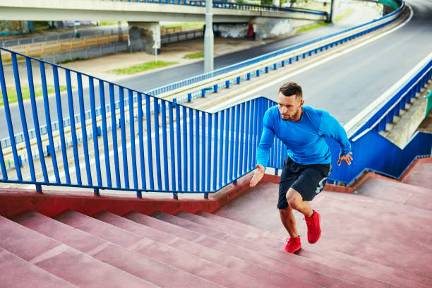 hombre atlético haciendo entrenamiento a intervalos corriendo en las escaleras en el entorno urbano - competition action animal close up fotografías e imágenes de stock