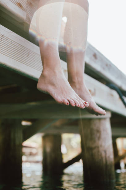 istock Woman relaxing on wooden dock 1151155929