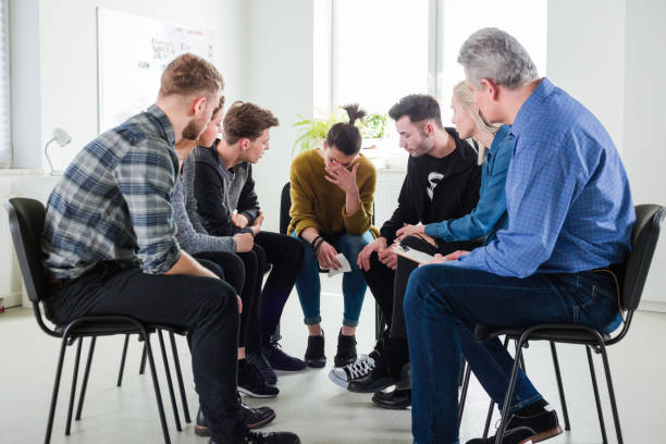 istock Students and therapist looking at depressed woman 1151155993