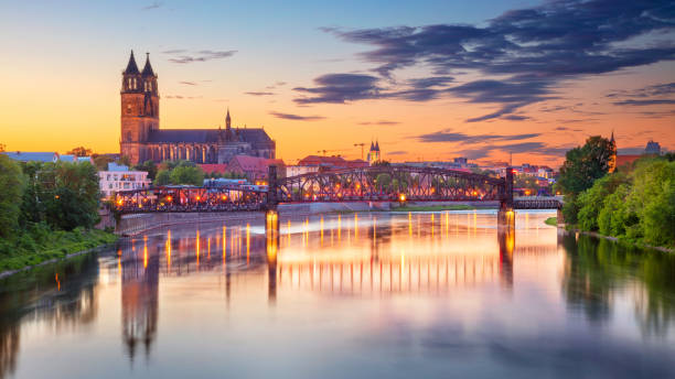 Magdeburg, Germany. Cityscape image of Magdeburg, Germany with reflection of the city in the Elbe river, during sunset. elbe river stock pictures, royalty-free photos & images