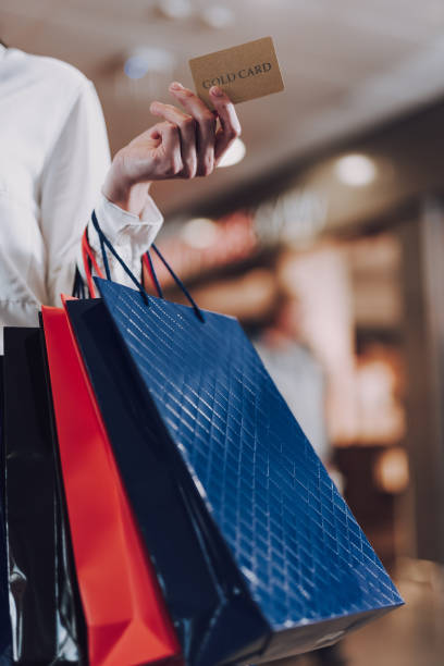 istock Lady is holding packets with purchases while going in mall 1151158600