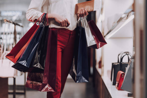 istock Elegant woman is buying handbag before flight 1151158645
