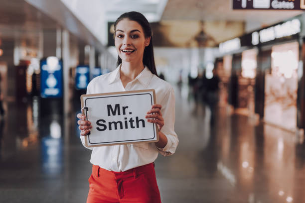 chica fácil de ir se reunirá con los huéspedes que lleguen al aeropuerto - airport sign fotografías e imágenes de stock